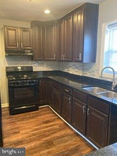 1120 44th Place Southeast Washington, DC 20019 - Photo 12 of 31 a kitchen with stainless steel appliances granite countertop a stove a sink and a microwave