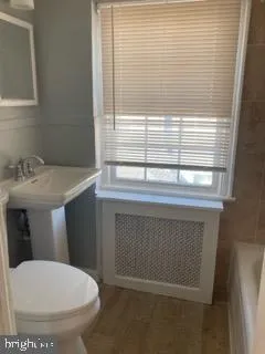 a bathroom with a toilet and a sink