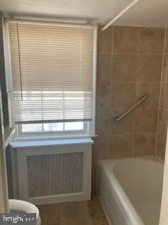 a bathroom with a bathtub and shower