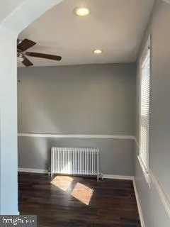 a view of a room with wooden floor and a window