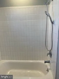 a bathroom with a shower and a bathtub
