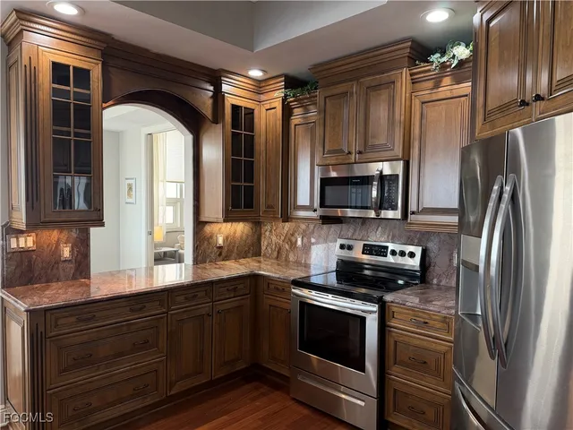 a kitchen with stainless steel appliances a stove microwave and a refrigerator