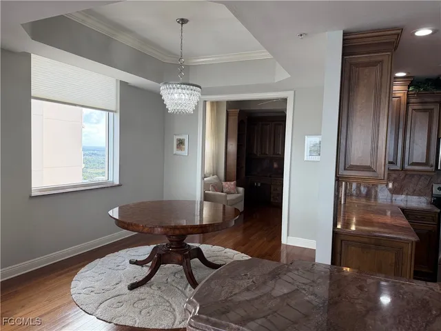 a workspace with chandelier and wooden floor
