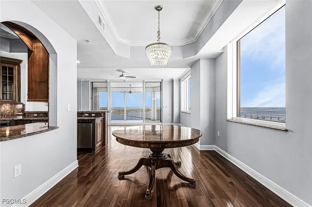 a bathroom with a granite countertop sink a large mirror and a bathtub