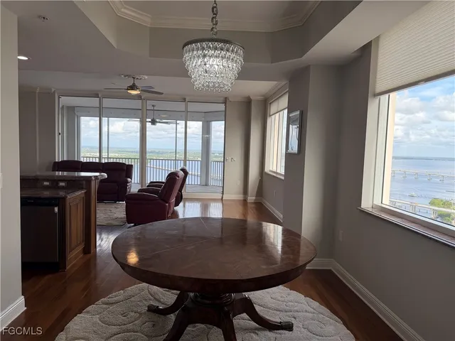 a view of a dining room with furniture wooden floor and chandelier