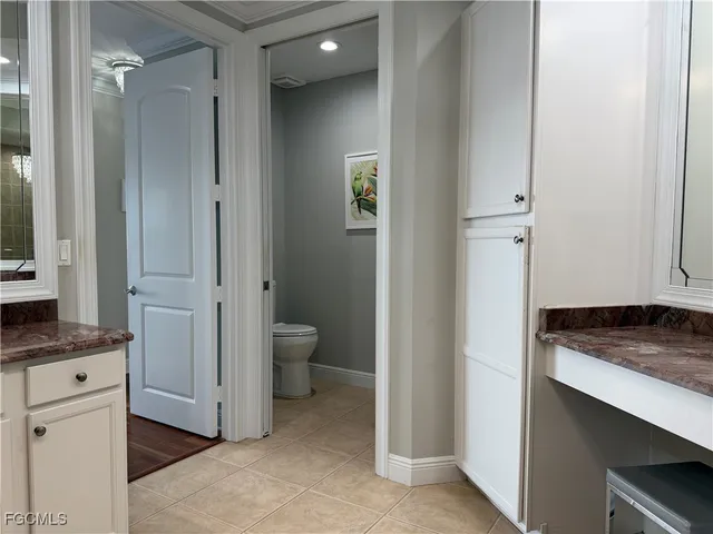 a bathroom with a granite countertop sink a toilet and shower