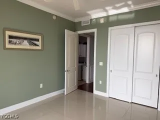 an empty room with closet and a bathroom