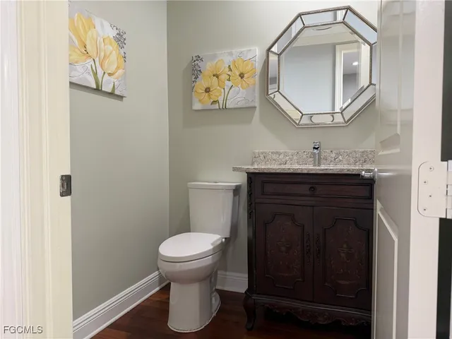 a bathroom with a toilet a sink and mirror