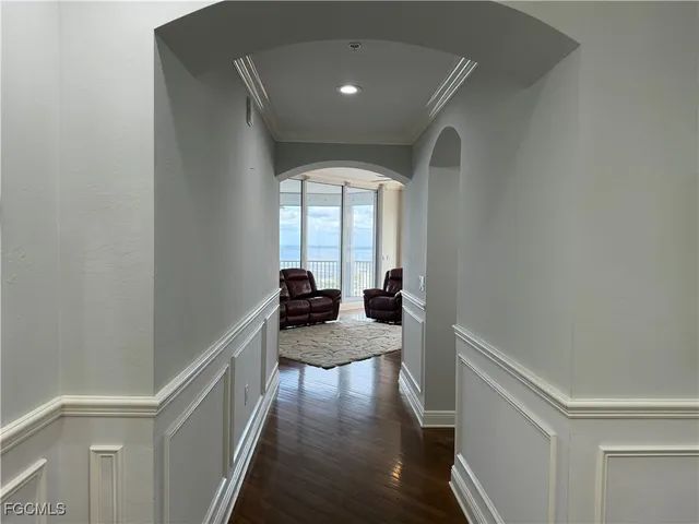 a hallway with a large mirror and furniture