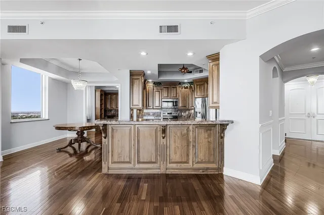 a bathroom with a granite countertop sink mirror vanity and toilet