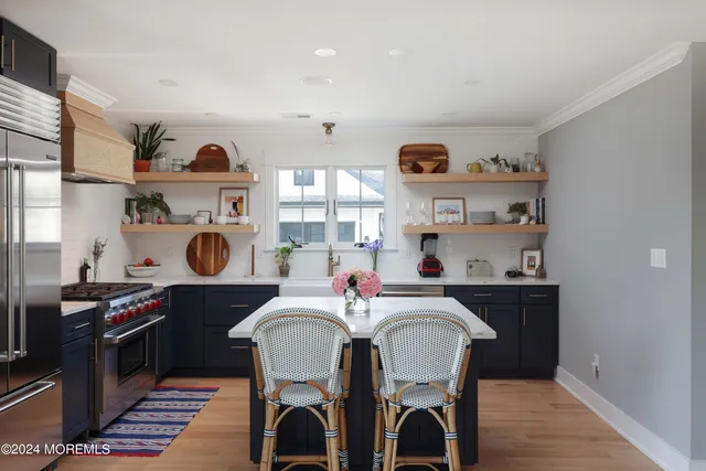 a kitchen with a dining table cabinets and stainless steel appliances
