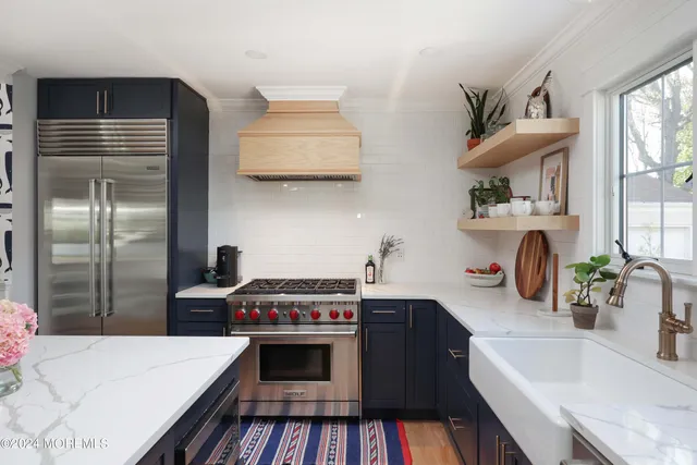 a kitchen with stainless steel appliances a sink stove and refrigerator