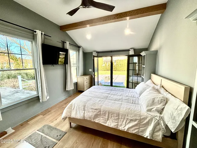 a bedroom with a large bed and a large window