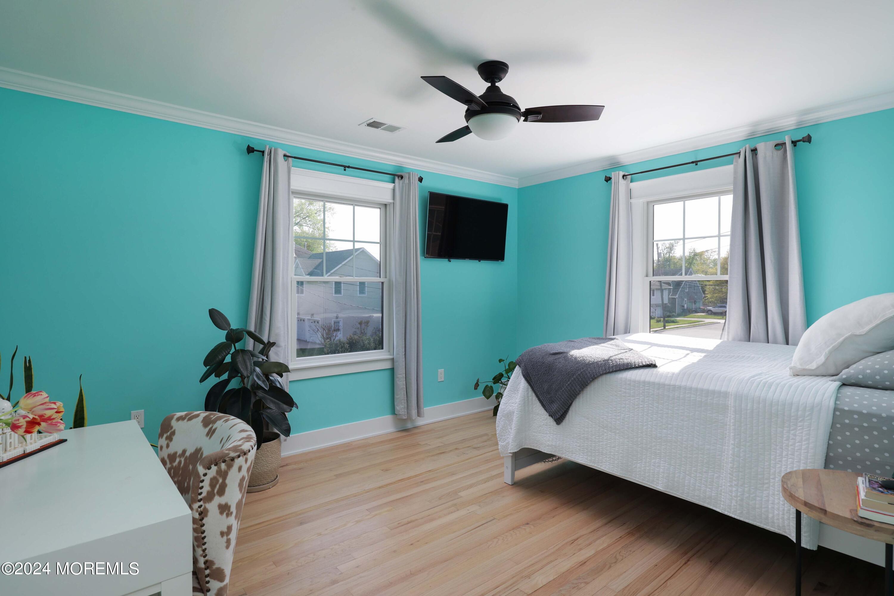 408 Central Avenue Spring Lake, NJ 07762 - Photo 22 of 46 a bedroom with a bed and a chandelier