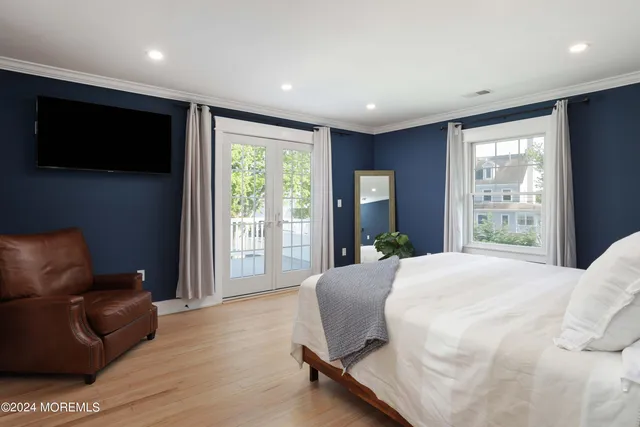 a spacious bedroom with a large bed and a flat screen tv