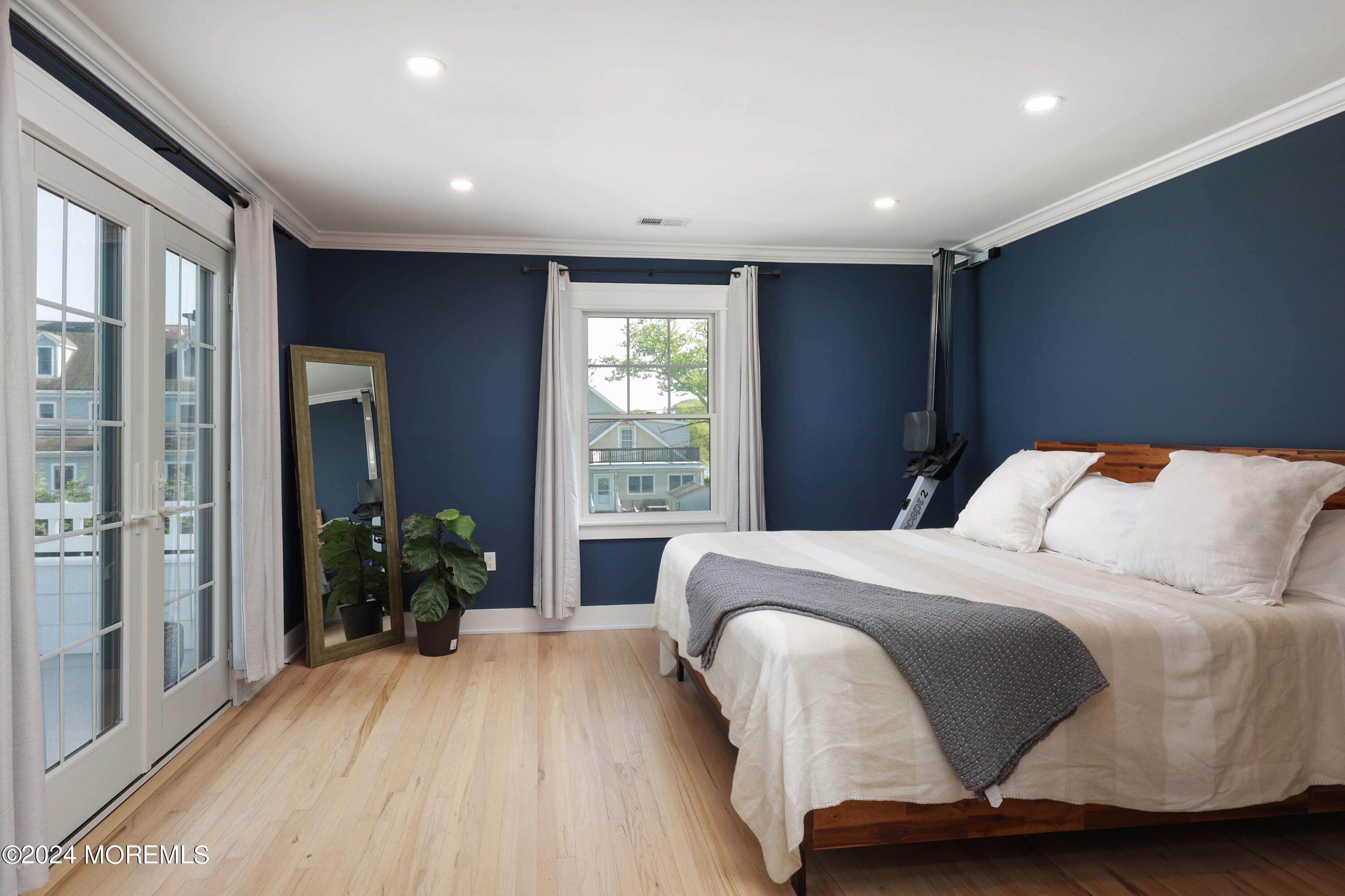 408 Central Avenue Spring Lake, NJ 07762 - Photo 26 of 46 a spacious bedroom with a bed and a potted plant