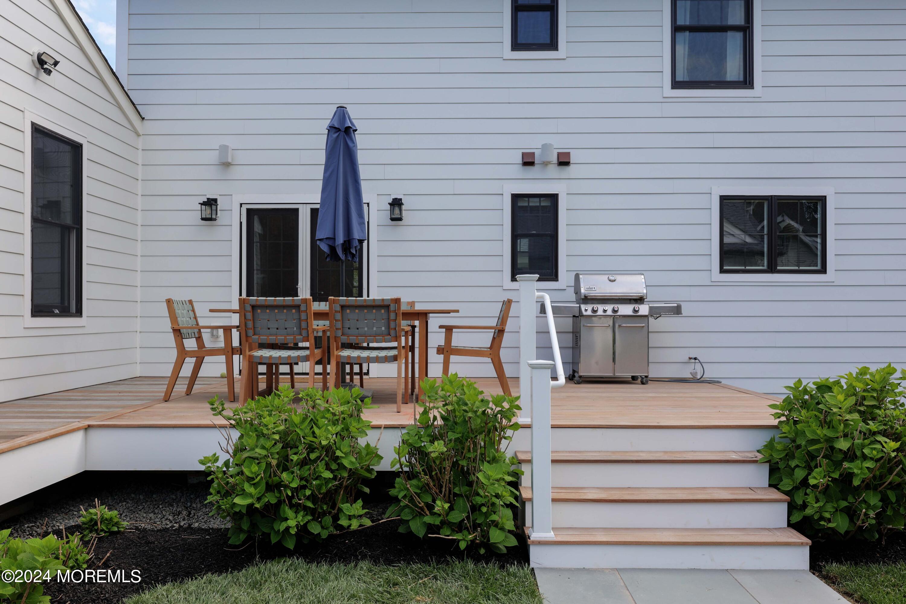408 Central Avenue Spring Lake, NJ 07762 - Photo 32 of 46 a patio with table and chairs and potted plants