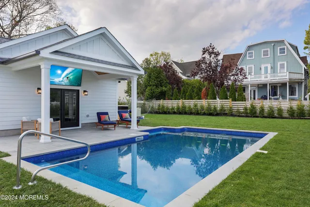 a view of house with swimming pool yard and outdoor seating