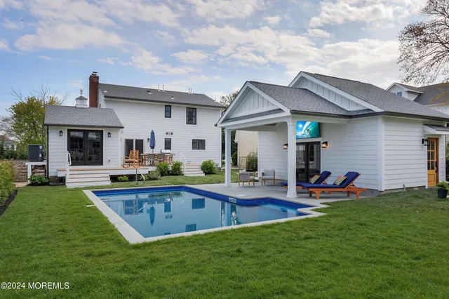 a view of a house with backyard sitting area and garden