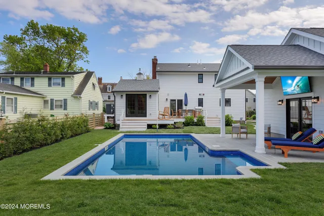 a view of a house with swimming pool and a yard