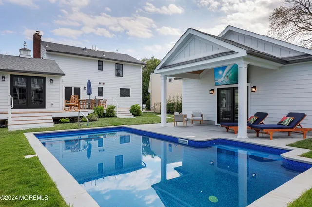 a swimming pool view with a outdoor seating