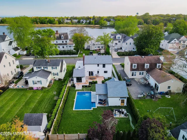 an aerial view of multiple houses with yard