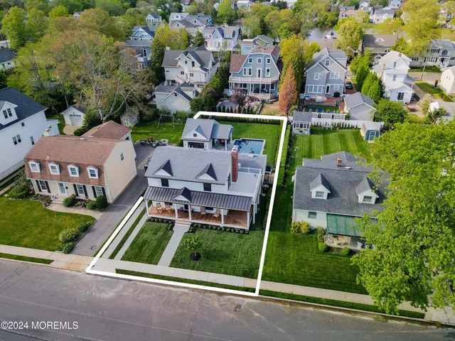 an aerial view of multiple houses with a yard