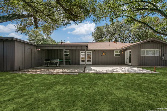 a house that has a tree in front of it