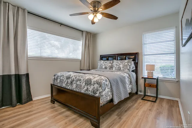 a bed sitting in a bedroom next to a window