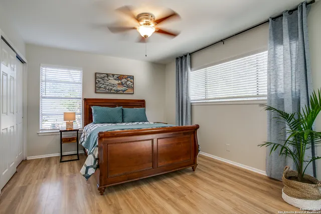 a bedroom with a bed and a potted plant