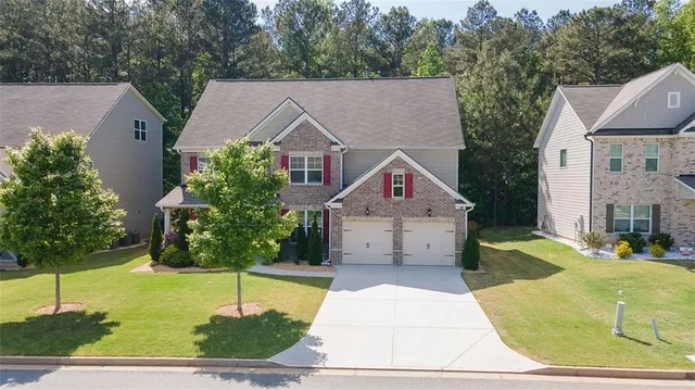 a aerial view of a house next to a yard