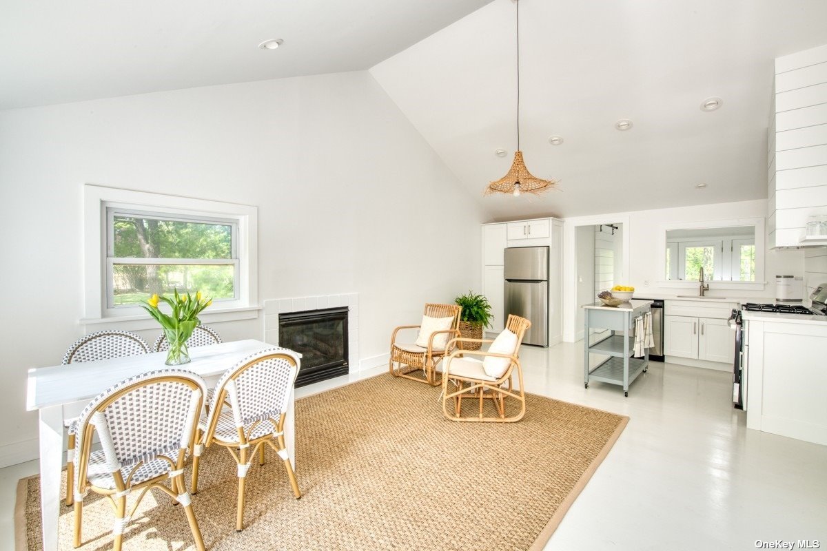 3670 Rocky Point Road East Marion, NY 11939 - Photo 1 of 1 a living room with furniture a dining table and a floor to ceiling window