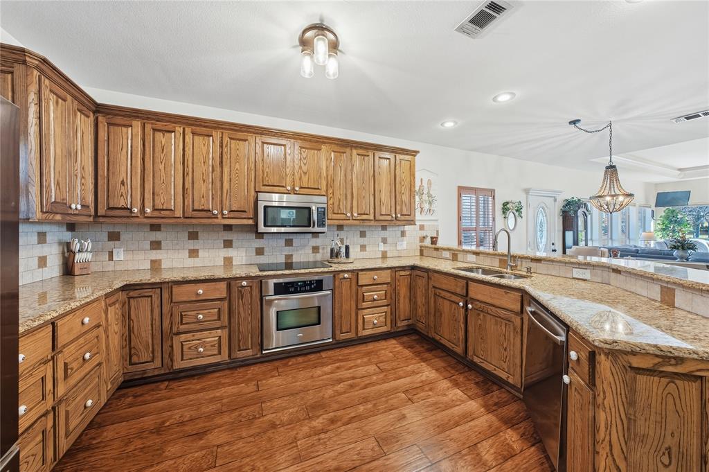 5262 Rio Vista Malakoff, TX 75148 - Photo 11 of 29 a large kitchen with stainless steel appliances granite countertop a stove sink and cabinets