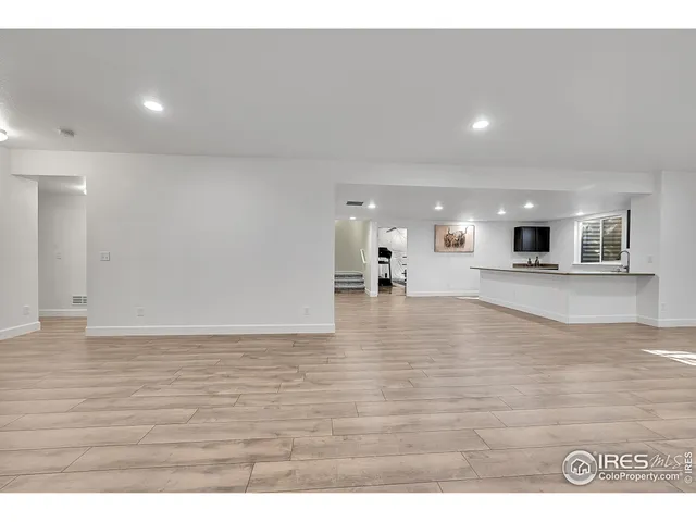 a view of a living room and kitchen with furniture