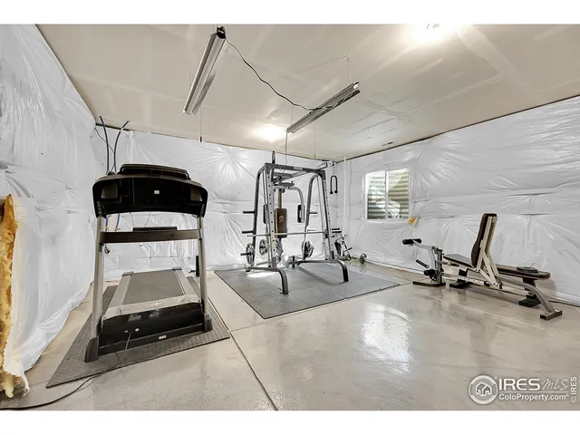 a room with gym equipment and a view of living room