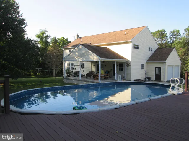 a front view of a house with sitting area and garden