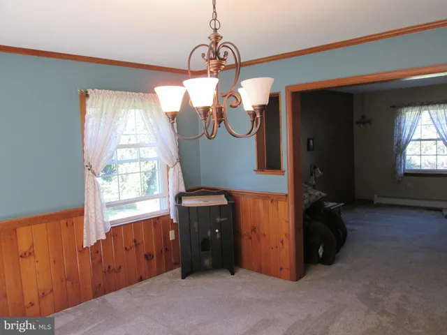 a kitchen with kitchen island a sink counter top space appliances and cabinets