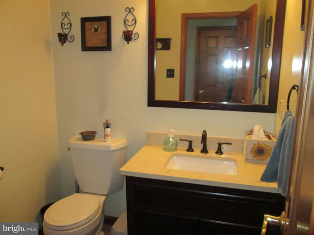 a bathroom with a sink toilet and a window