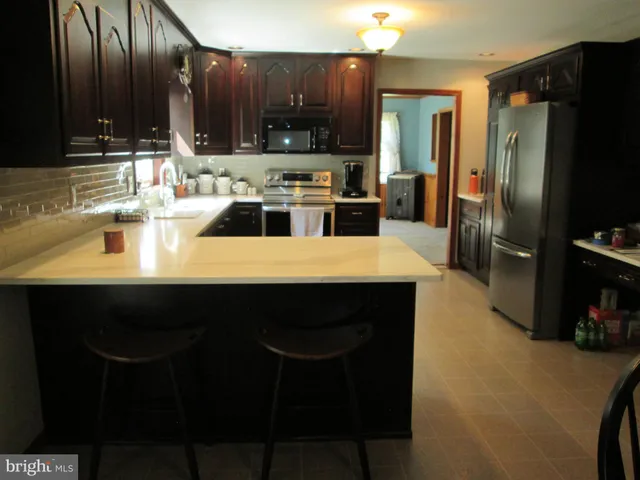 an empty room with a chandelier fan