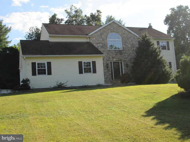 a view of a house with pool and a yard