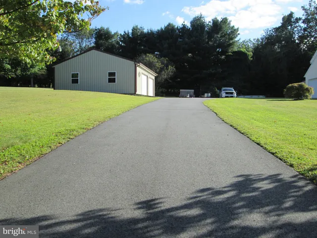 a front view of house along with trees