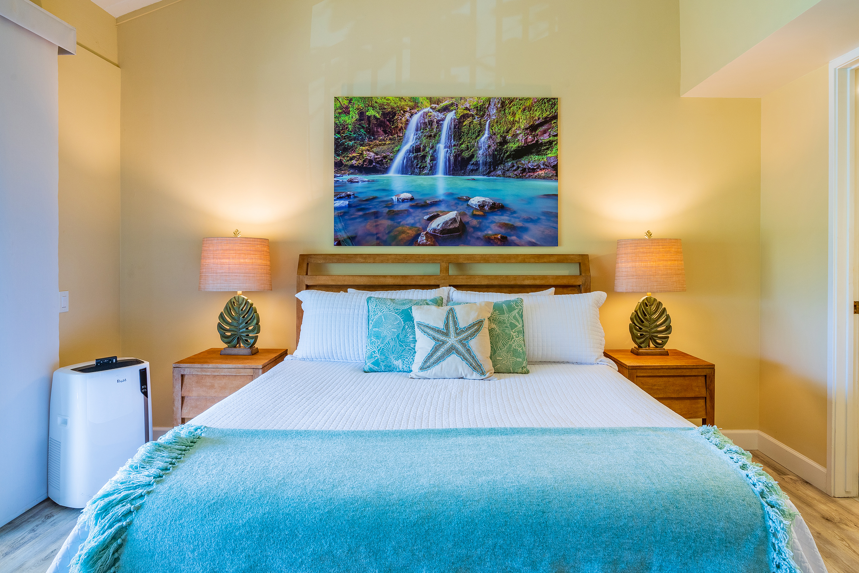 3811 Edward Road, Unit 2309 Princeville, HI 96722 - Photo 14 of 27 a bedroom with a bed and painting on the wall