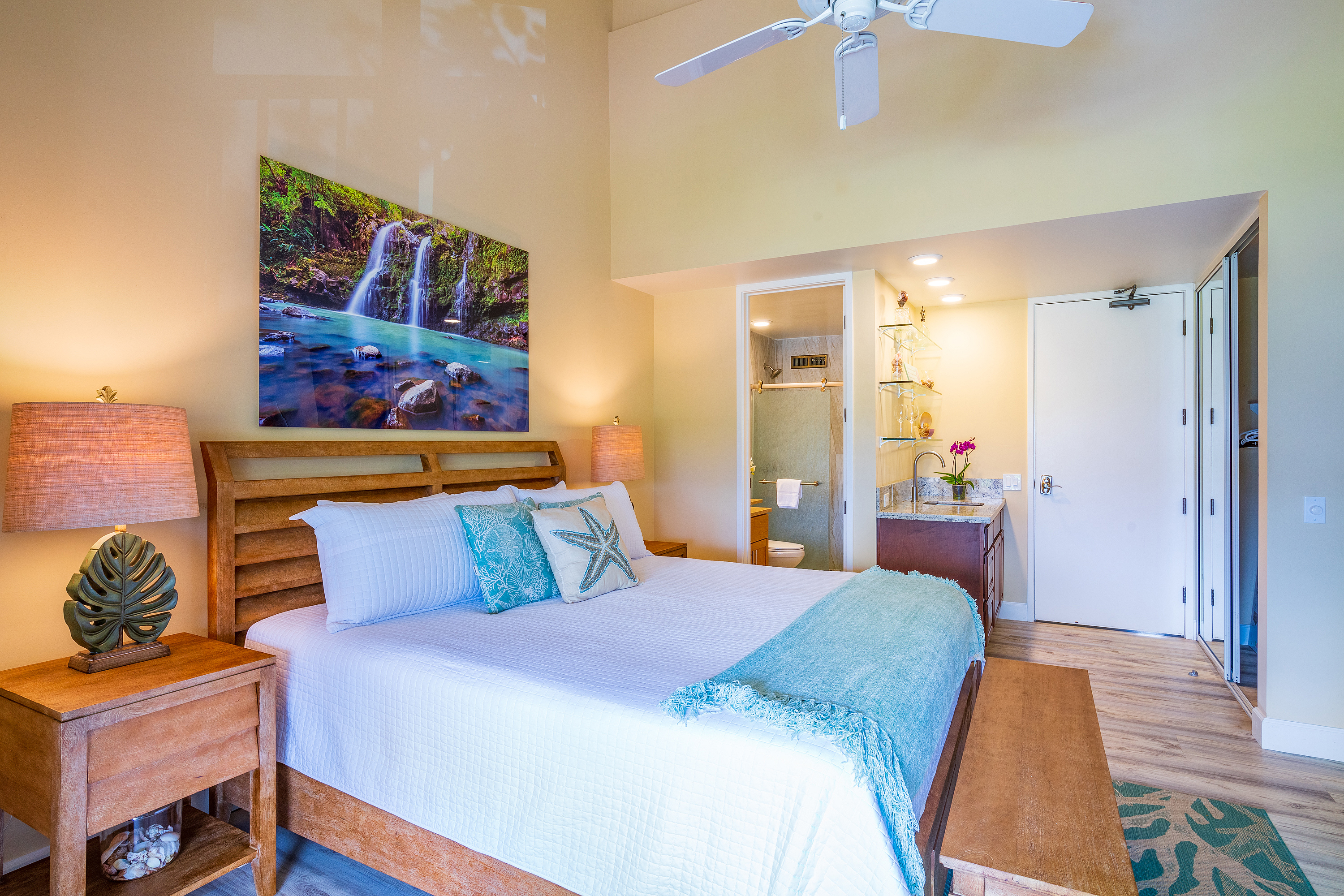 3811 Edward Road, Unit 2309 Princeville, HI 96722 - Photo 15 of 27 a bedroom with a bed and a painting on the wall