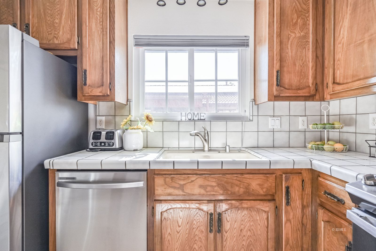 412 Lorene Court Ridgecrest, CA 93555 - Photo 7 of 31 a kitchen with stainless steel appliances granite countertop a sink a stove and a refrigerator