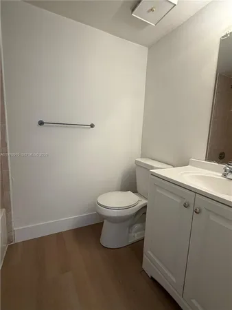 a white toilet sitting next to a bathroom sink
