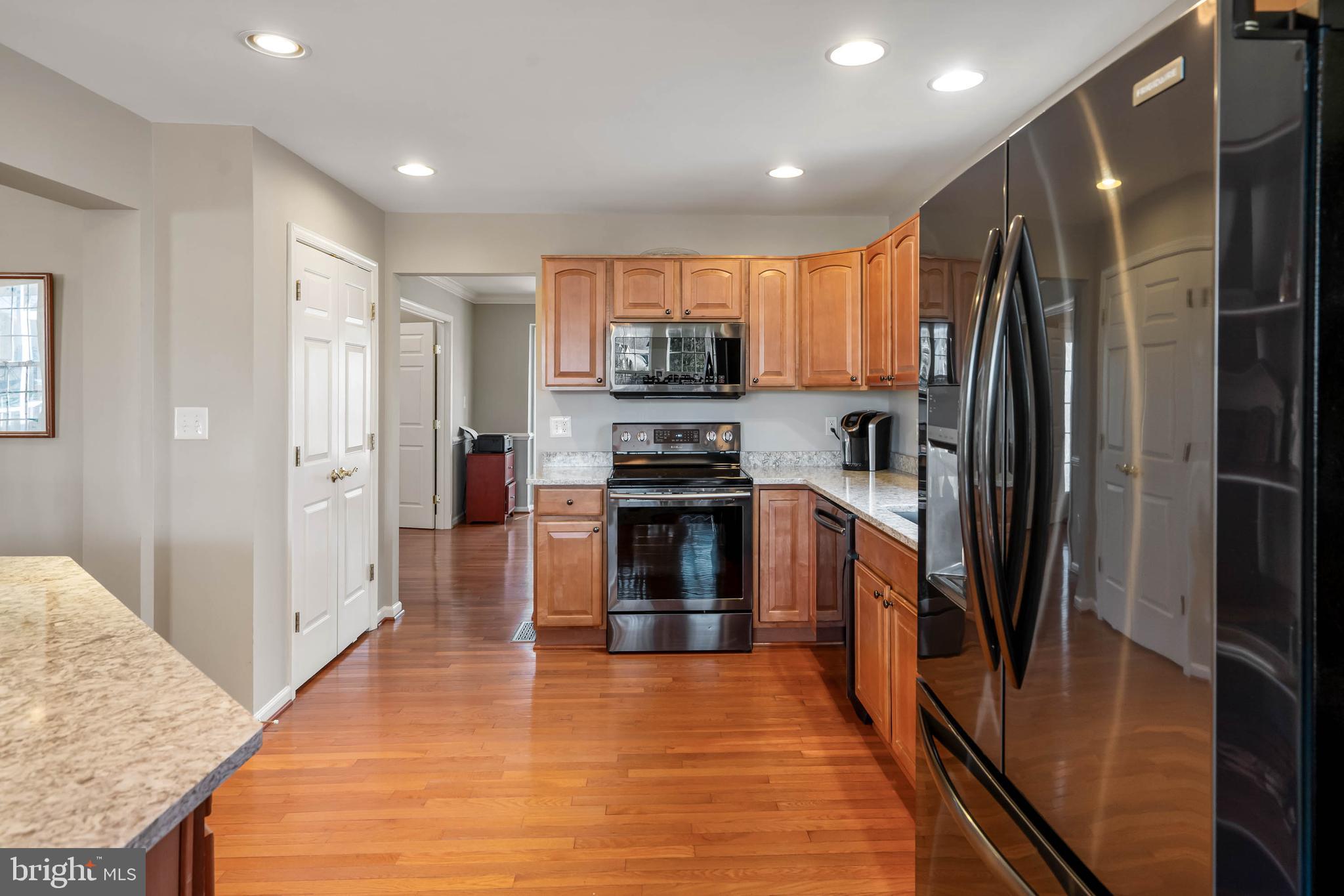 37140 Lord Baltimore Lane Ocean View, DE 19970 - Photo 11 of 56 a kitchen with granite countertop a refrigerator and a stove top oven