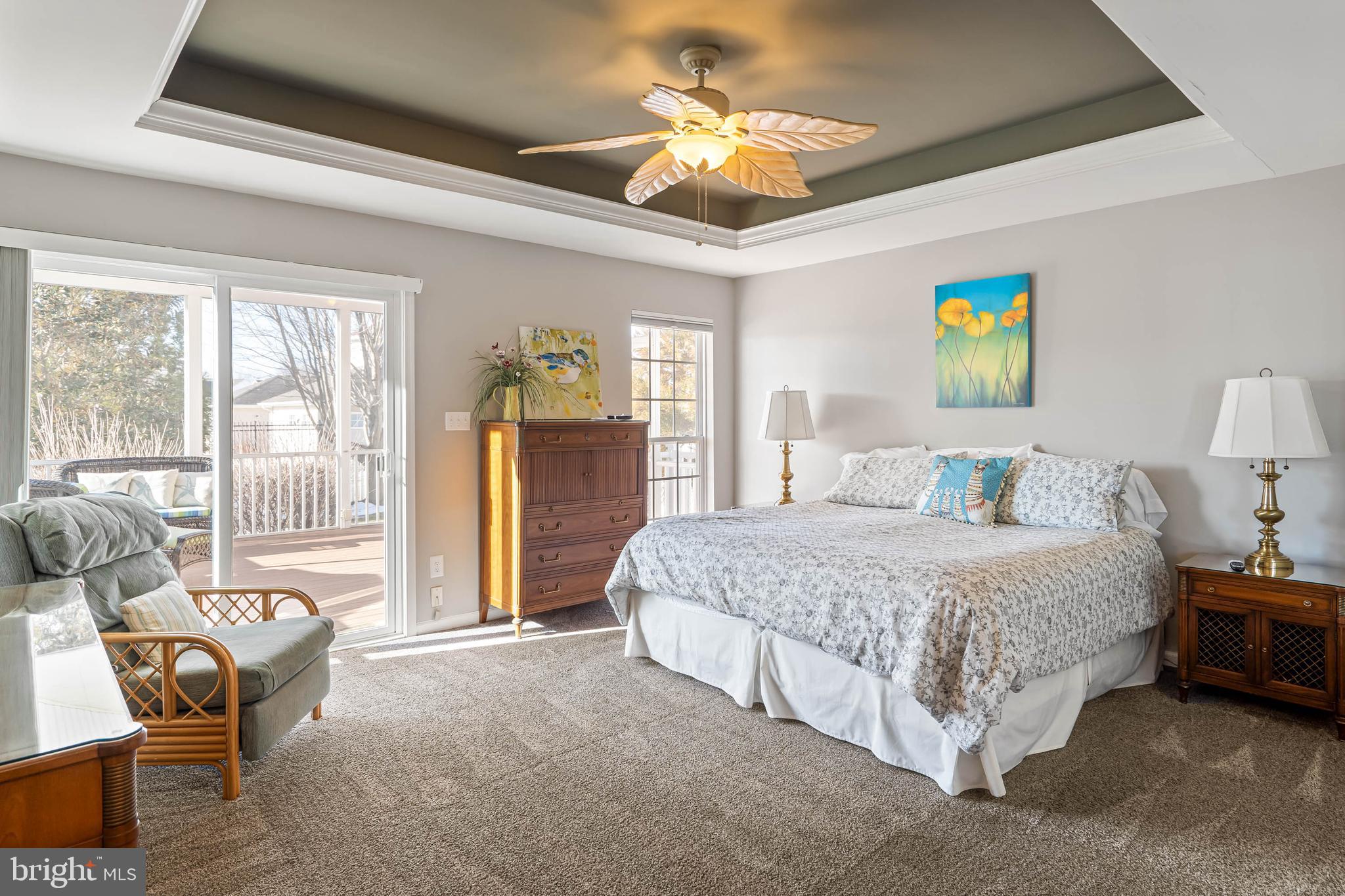 37140 Lord Baltimore Lane Ocean View, DE 19970 - Photo 20 of 56 a spacious bedroom with a bed and a chandelier