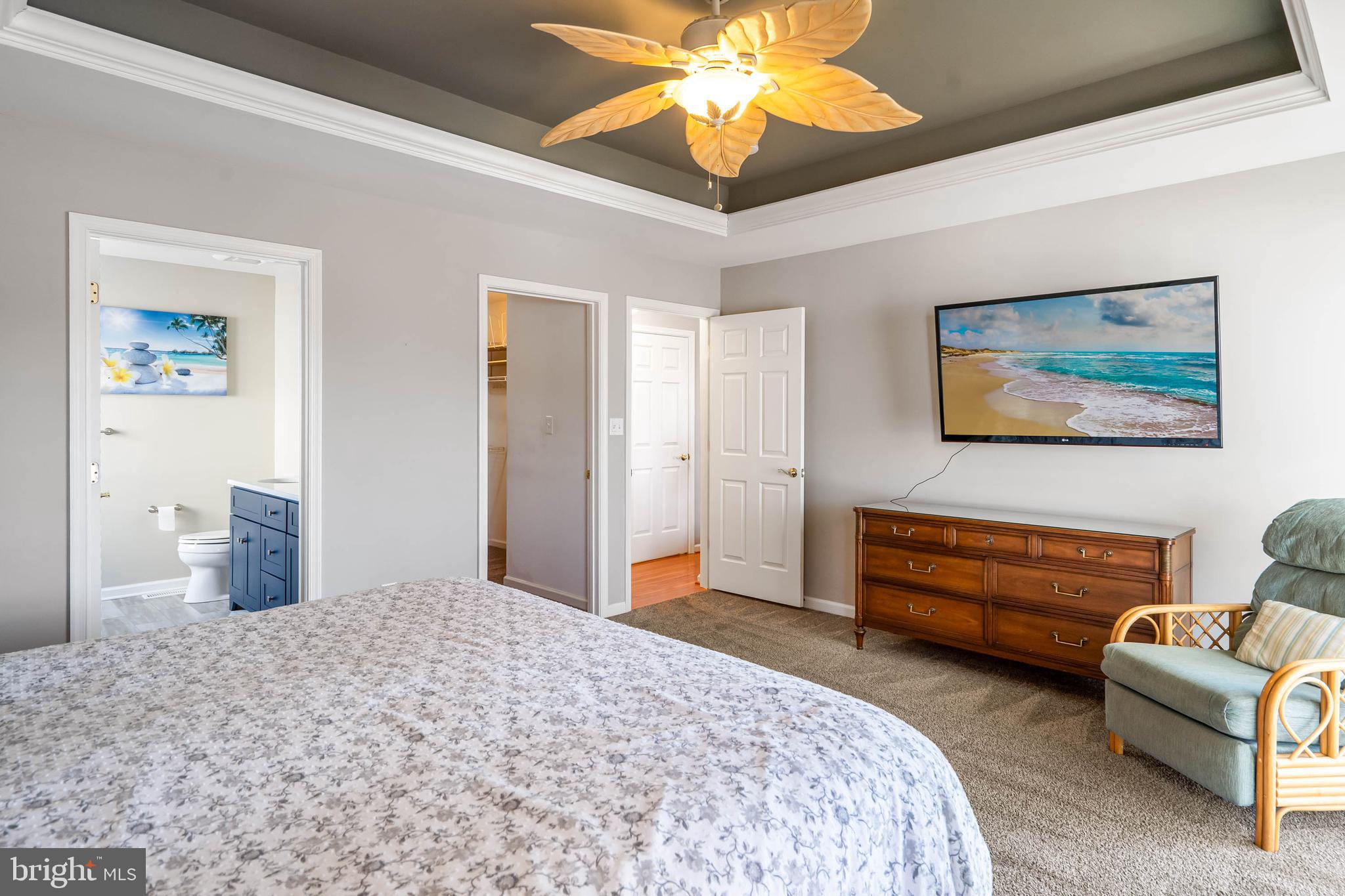 37140 Lord Baltimore Lane Ocean View, DE 19970 - Photo 21 of 56 a bedroom with furniture and a chandelier