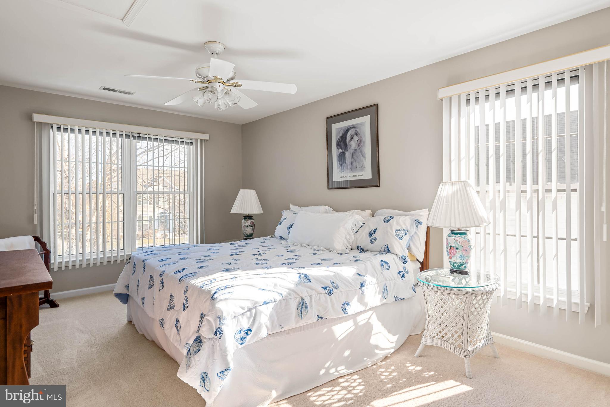 37140 Lord Baltimore Lane Ocean View, DE 19970 - Photo 29 of 56 a bedroom with a large bed and a chandelier