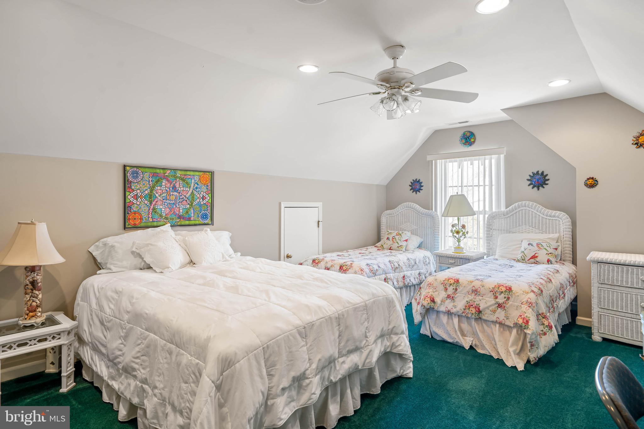 37140 Lord Baltimore Lane Ocean View, DE 19970 - Photo 33 of 56 a bedroom with two beds and a chandelier
